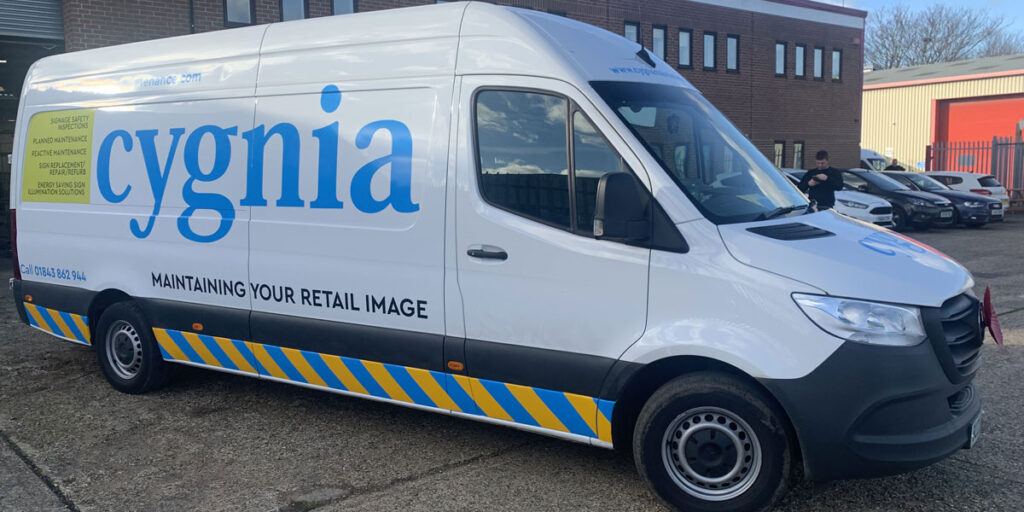 The front-quarter view of a new van with livery for Cygnia Signage Maintenance